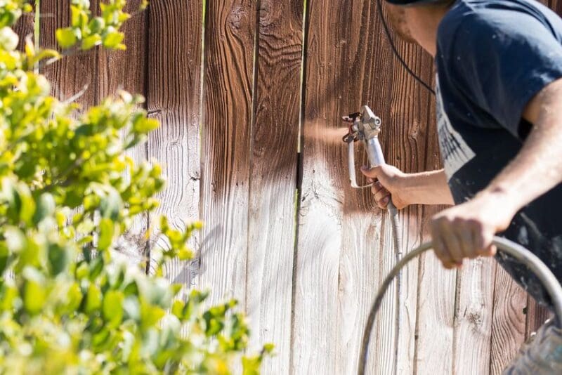 applying stain fencing